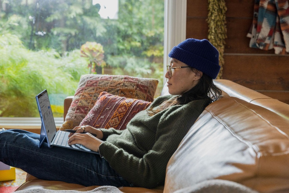 a-person-sitting-at-a-table-using-a-laptop