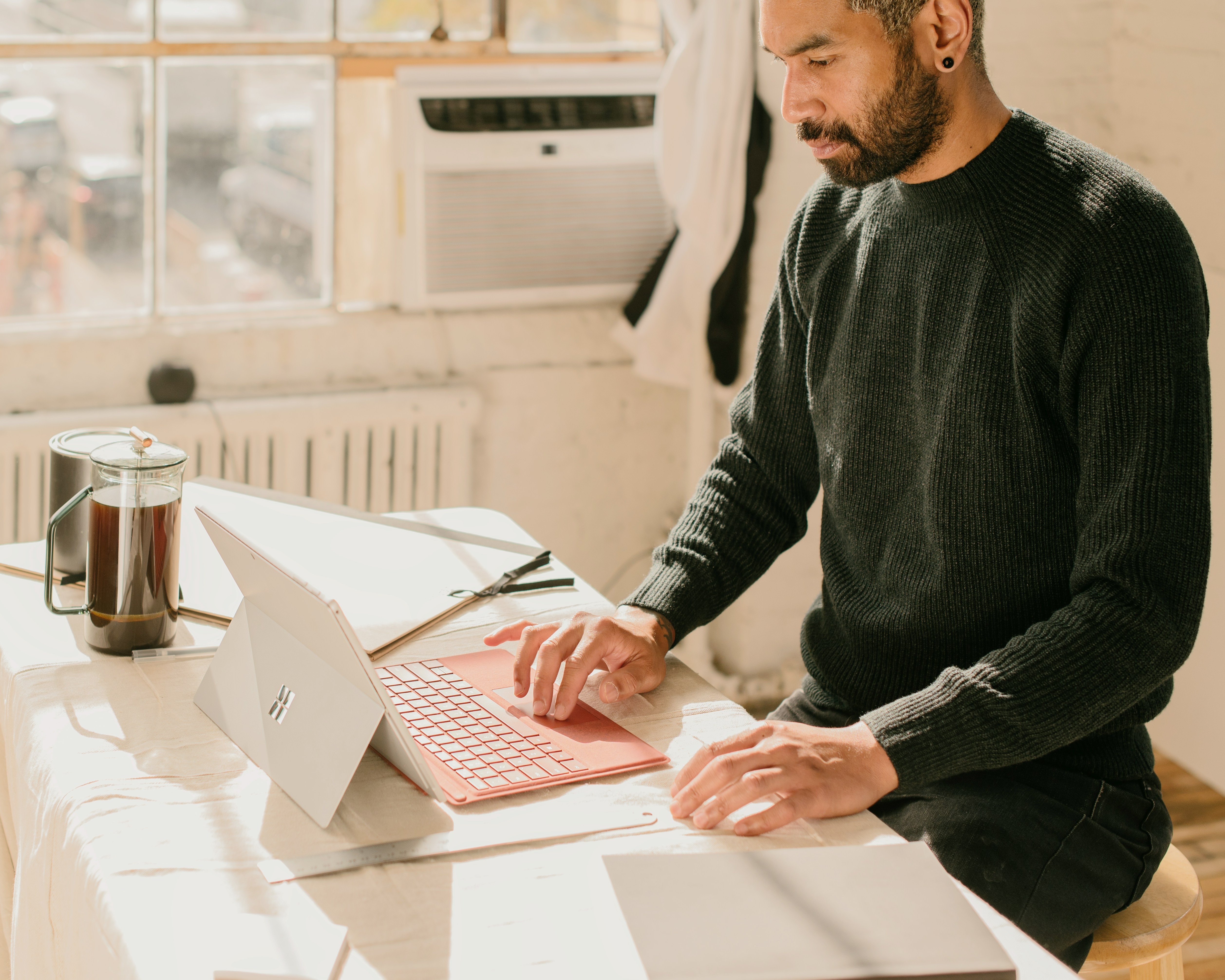 https://unsplash.com/photos/a-man-sitting-at-a-table-using-a-laptop-computer-EXY9jF4iYm4