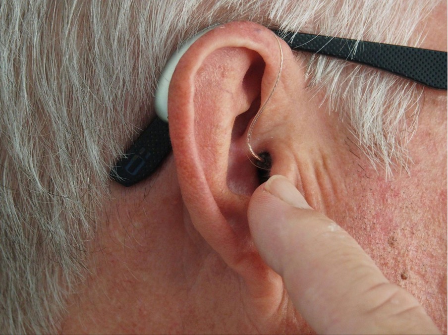 person-wearing-hearing-aid-with-glasses