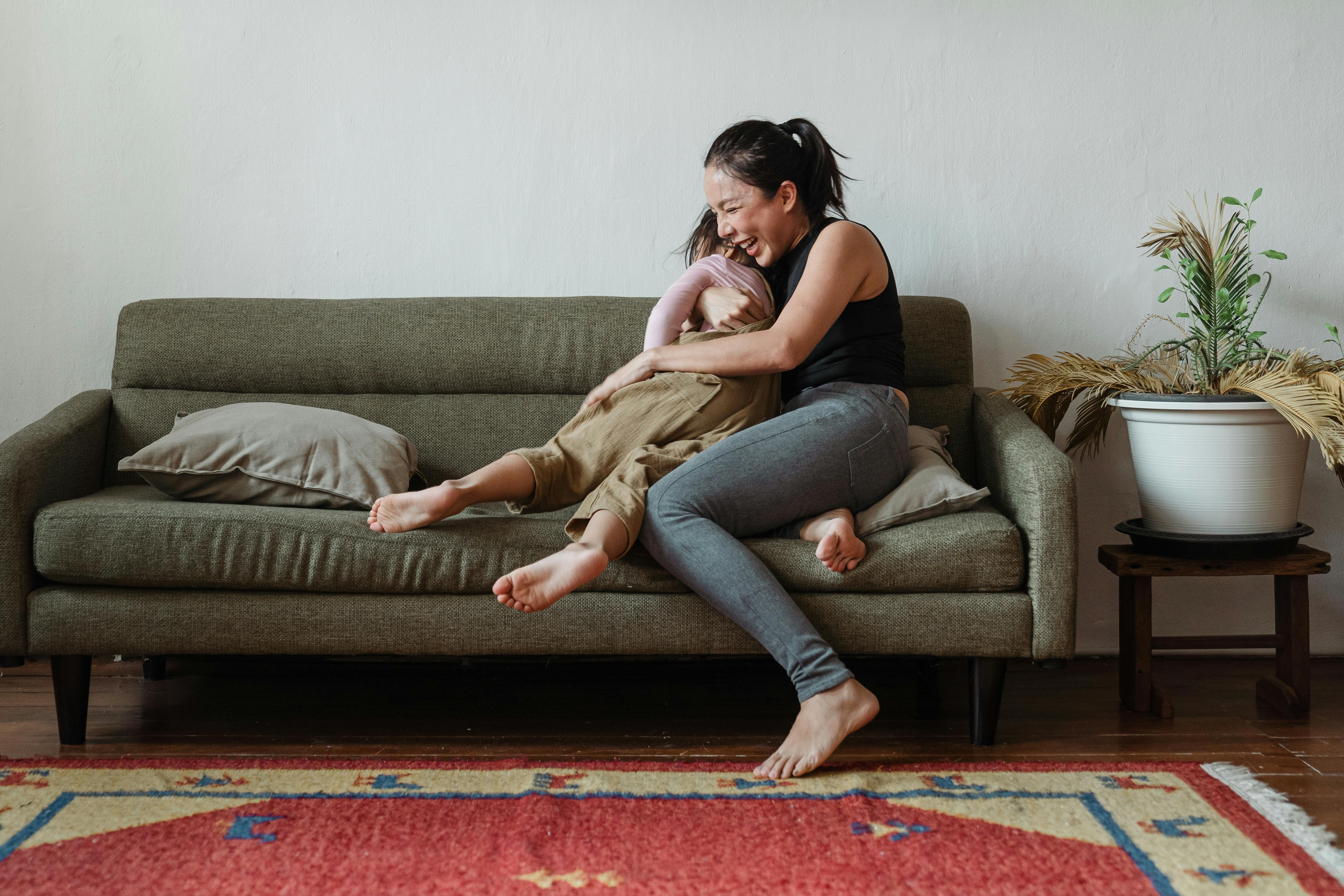 https://www.pexels.com/photo/photo-of-woman-sitting-on-couch-while-hugging-her-child-4473625/