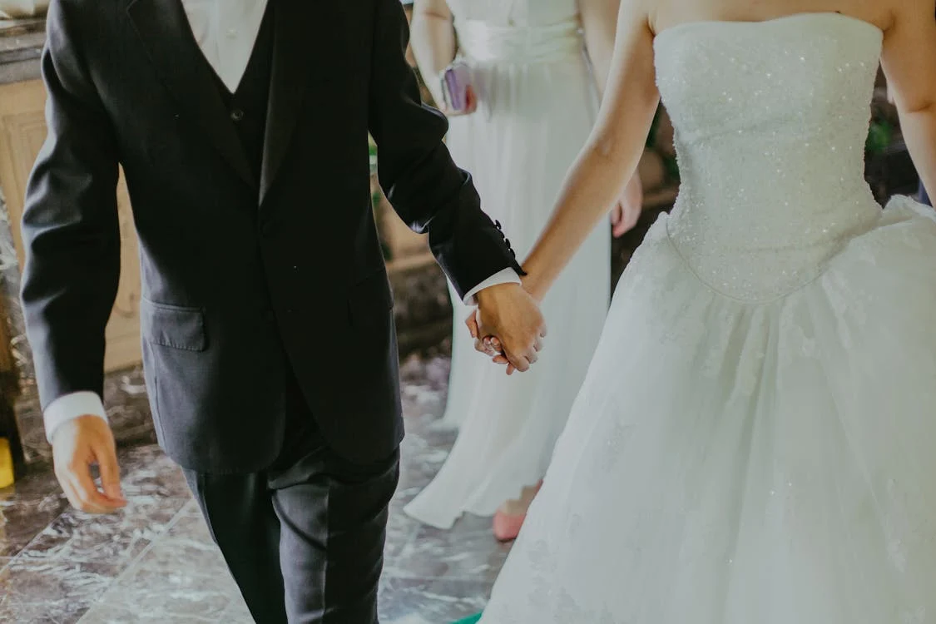 https://www.pexels.com/photo/woman-wearing-white-wedding-gown-holding-hands-with-man-while-walking-1043902/